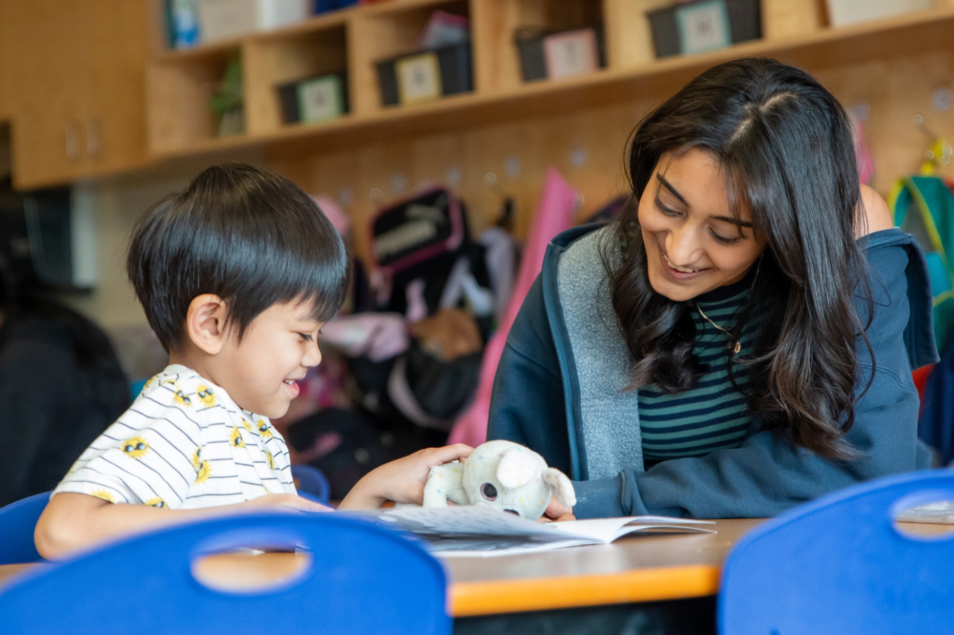 A high school student reads with a kindergarten student